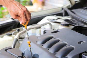 Close-up checking oil machine on a car.