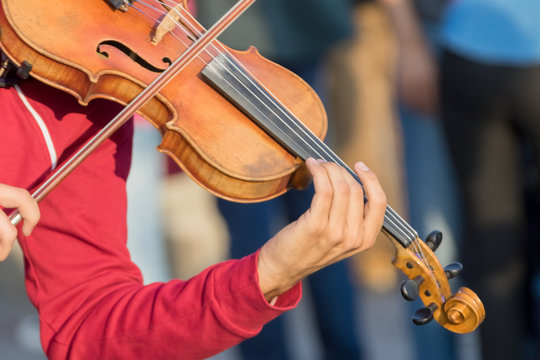 Street violinist with a violin and bow in his hands
