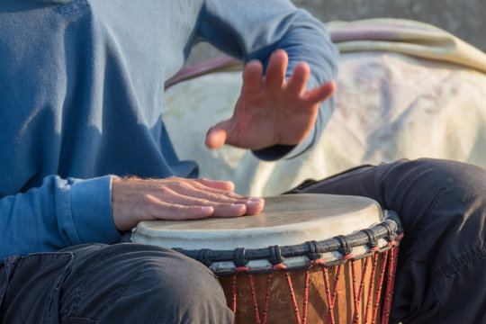 A street musician plays the drums