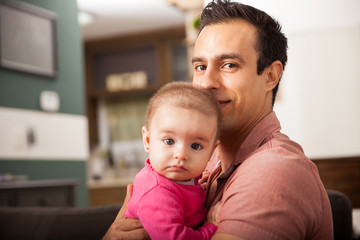 Father and baby daughter relaxing at home