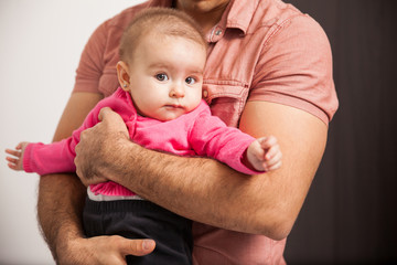 Baby girl in the arms of her father