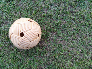 Rattan ball, takraw ball on green grass