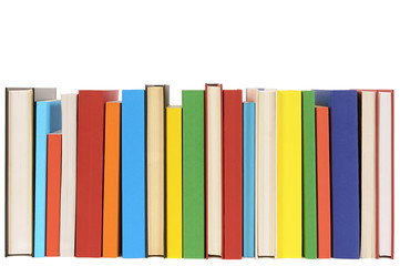 Row line of colorful books isolated on white background school college library bookshelf photo