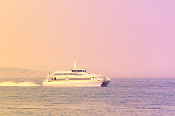 Fototapeta na wymiar Big pleasure boat on the background of the water surface
