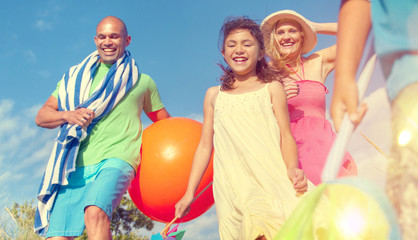 Fototapeta na wymiar Cheerful Family Going to the Beach Holiday Enjoying Concept
