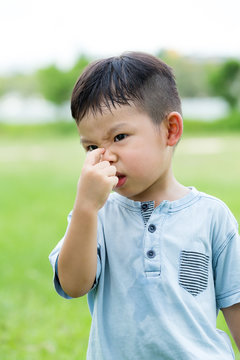 Little Boy Holding His Nose Of Bad Smell