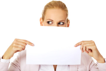 Business woman covering mouth and nose with blank paper sheet