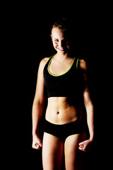 Young athletic woman in black sports underwear