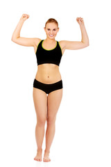 Young athletic woman showing muscles