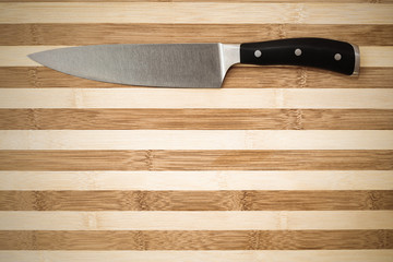 20 cm chef's knife on a bamboo cutting board