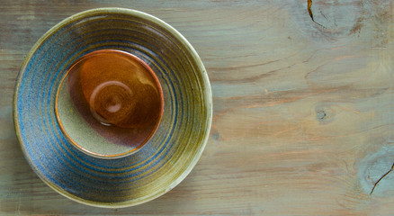 Pottery on a matching wooden background in aqua tones