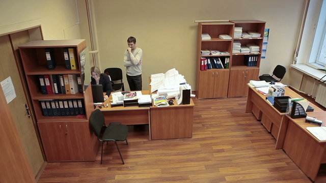 Coworkers talking together in office room, engineering department, man and woman
