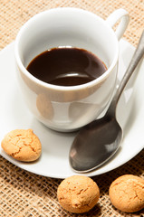 freshly brewed espresso in a cup and biscuit