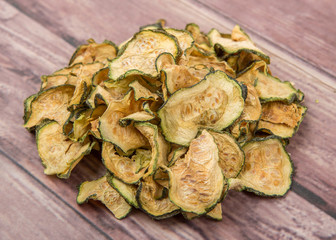 Dried zucchini or courgette over wooden background