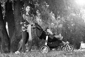 Fototapeta na wymiar walk women with stroller summer sunlight
