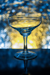 Whiskey glass empty on the background bokeh bright colors.