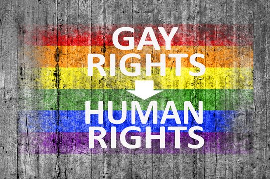 Gay Rights Are Human Rights and LGBT flag painted on background texture gray concrete