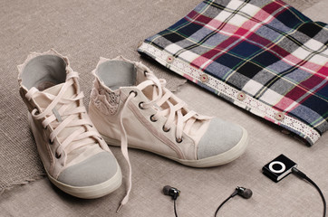 Fototapeta na wymiar Clothing set. Womens sneakers and plaid shirt with lace insertio