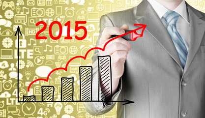 business man drawing growth graph for year 2015