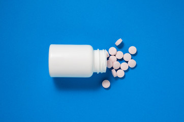 Pill bottle on blue background