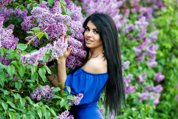 Beautiful smiling young woman with lilac flowers