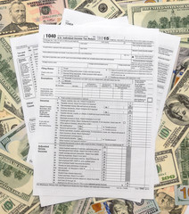 Tax form 1040 on US dollars background
