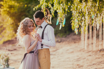 Obraz premium bride and groom in rustic style outdoor. Vintage toned