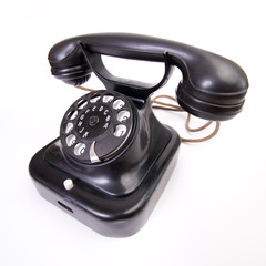 Old-fashioned telephone on the white backing 