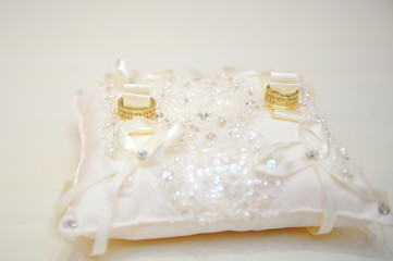 gold wedding rings on the pincushion for ceremony