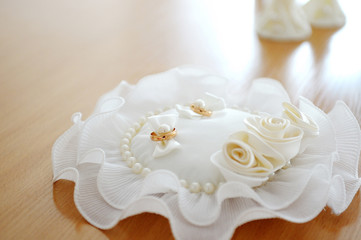 gold wedding rings on the pincushion for ceremony