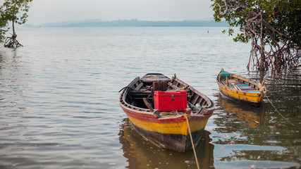 Naklejka na ściany i meble Fishermen's boats in the mangroove bay.