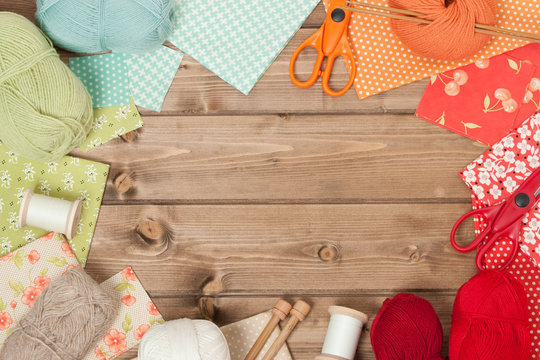 Sewing And Knitting Accessories. Fabric, Yarn Balls. Wooden Tabl