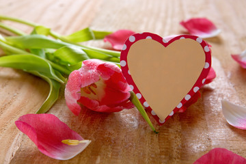 Naklejka na ściany i meble Bouquet of beautiful tulips with heart-shaped card.