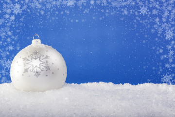 white Christmas balls in the snow