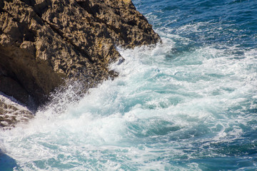 ocean waves crashing on the rocks with white foam