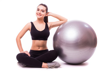 Fototapeta na wymiar woman making exercise with pilates ball, against white background