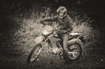 Fototapeta na wymiar Enduro racer sitting on his motorcycle