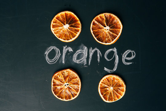 four cup sliced orange on a black background board