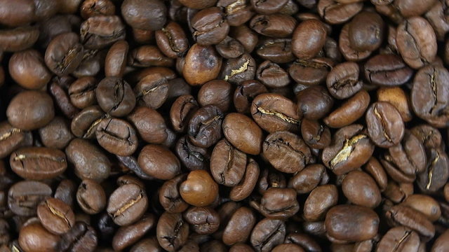 Background of the rotating coffee beans closeup
