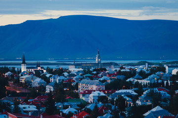 Beautiful super wide-angle aerial view of Reykjavik, Iceland with harbor and skyline mountains and...