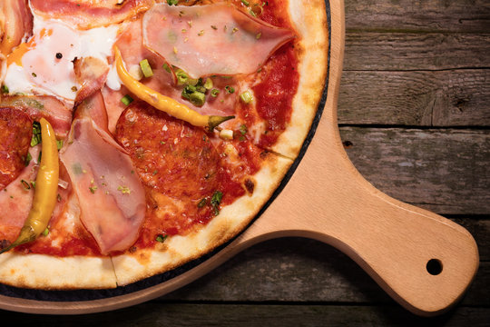 Hot spicy pepperoni pizza with sausage, ham and chilly pepeer