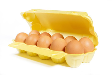 Chicken's eggs in box yellow color on white background