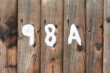 House number 98A sign painted on gate