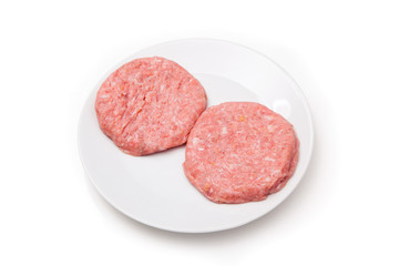 Raw crocodile meat burgers isolated on a white studio background