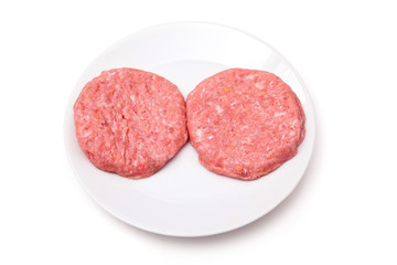 Raw crocodile meat burgers isolated on a white studio background