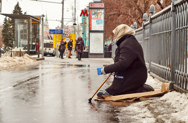 Female beggar asks for money on the Moscow street  