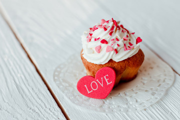 Beautiful cakes cupcakes on a white wooden table from the heart