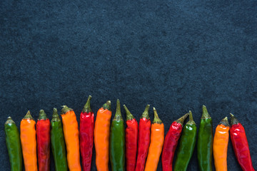 Vibrant peppers on dark slate