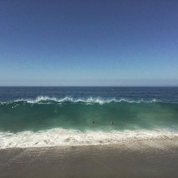 Father And Son Swimming In Ocean