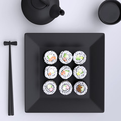 Plate with sushi, chopsticks and tea cup. View from above.